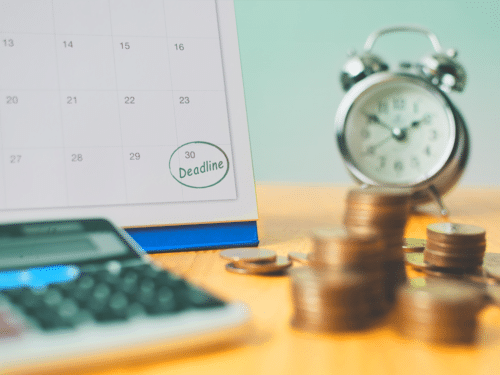 a calendar, clock, calculator and coins represent making a content marketing plan on a budget